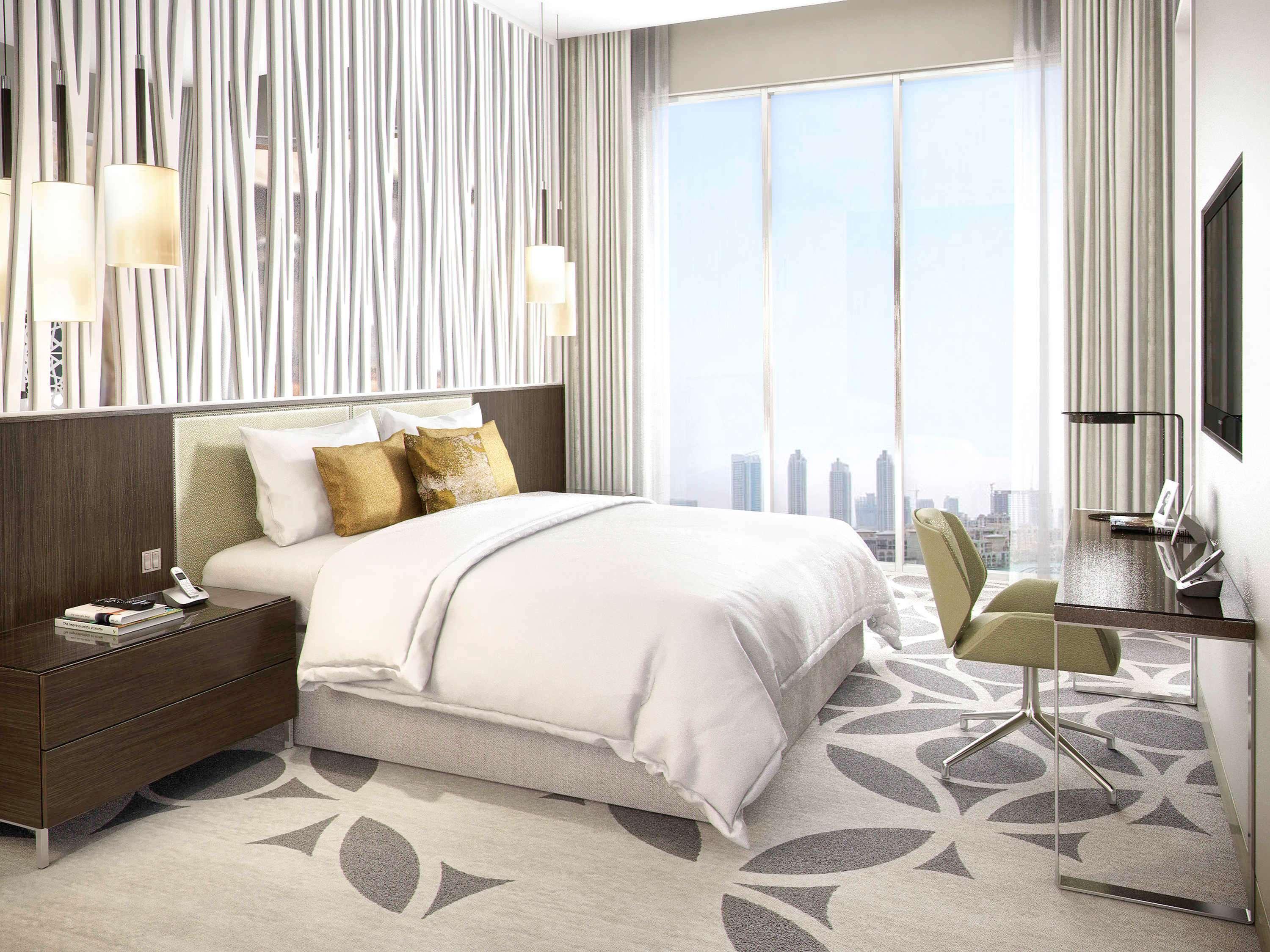 Grand Mercure Dubai City Exterior photo The photo shows a modern hotel room with a clean and stylish design. It features a large bed with white linens and decorative pillows. Beside the bed, there's a dark wooden nightstand. On the opposite side, there is a small work desk with a chair, an